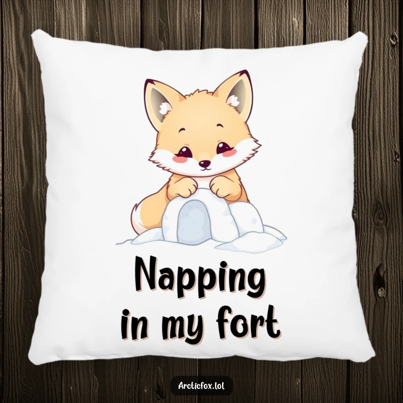 Funny kawaii arctic fox focused on building a tiny snow fort with its paws, on a soft decorative pillow.