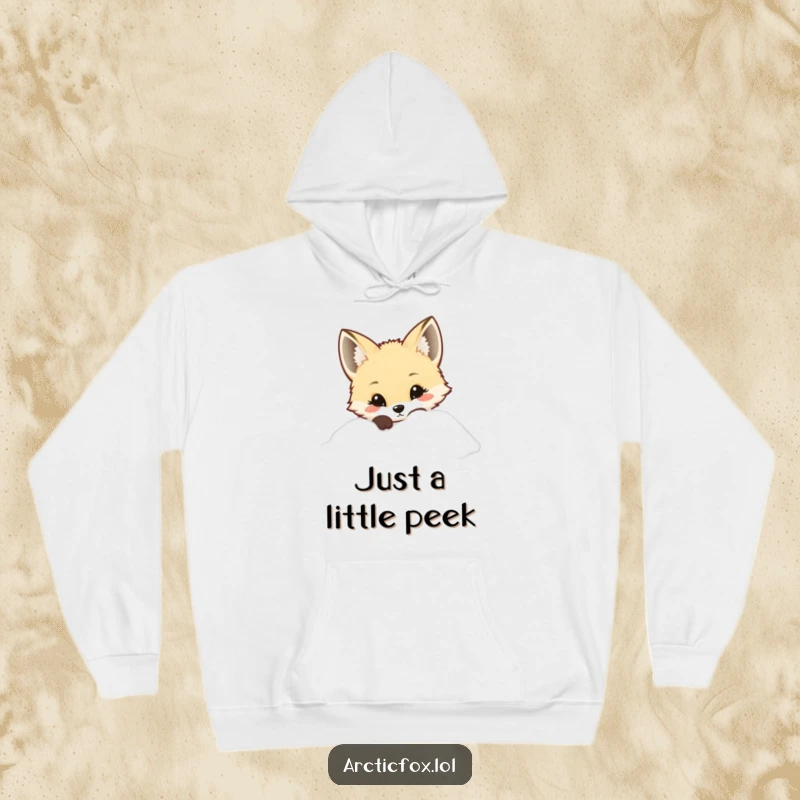 Kawaii Arctic fox peeking curiously from snow, featured on a cozy hoodie, great for winter comfort.
