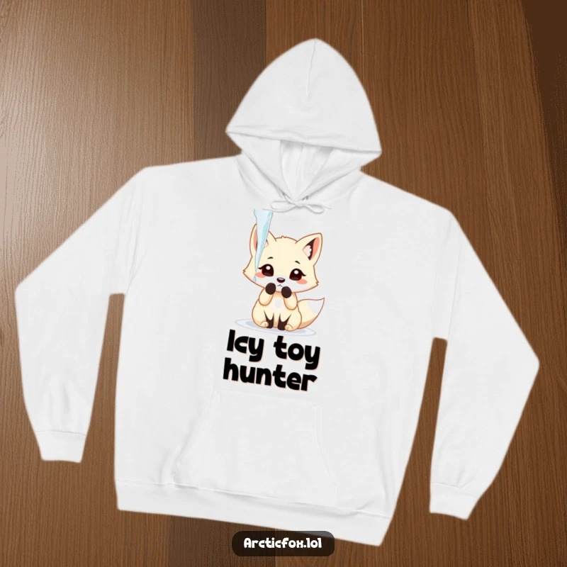 Funny arctic fox playfully batting at a dangling icicle with its paw, depicted on a cozy hoodie.