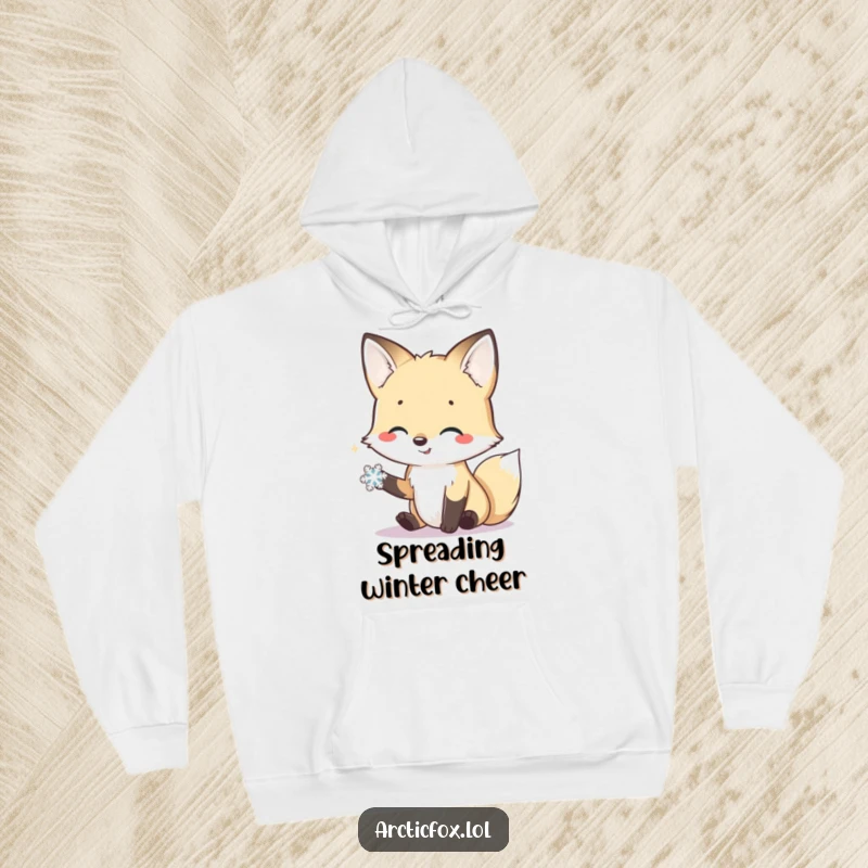 Funny hoodie depicting a smiling arctic fox extending a friendly paw towards a delicate snowflake, symbolizing gentle connection.