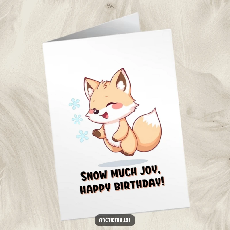Funny Free Printable Birthday Card featuring a kawaii arctic fox joyfully chasing a swirling snowflake in a winter wonderland.