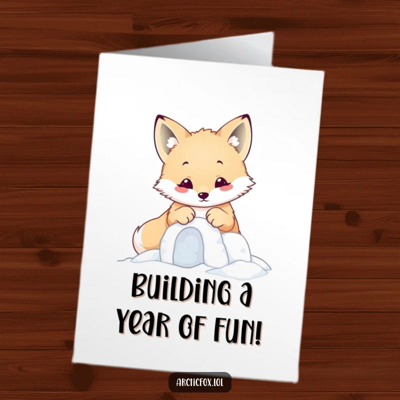 Funny Free Printable Birthday Card featuring a kawaii arctic fox diligently building a tiny snow fort with its paws.