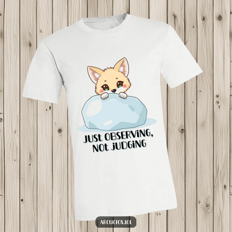 Funny T-Shirt: An arctic fox with wide, curious eyes peeks from behind a large icy boulder, showing off its playful surprise.